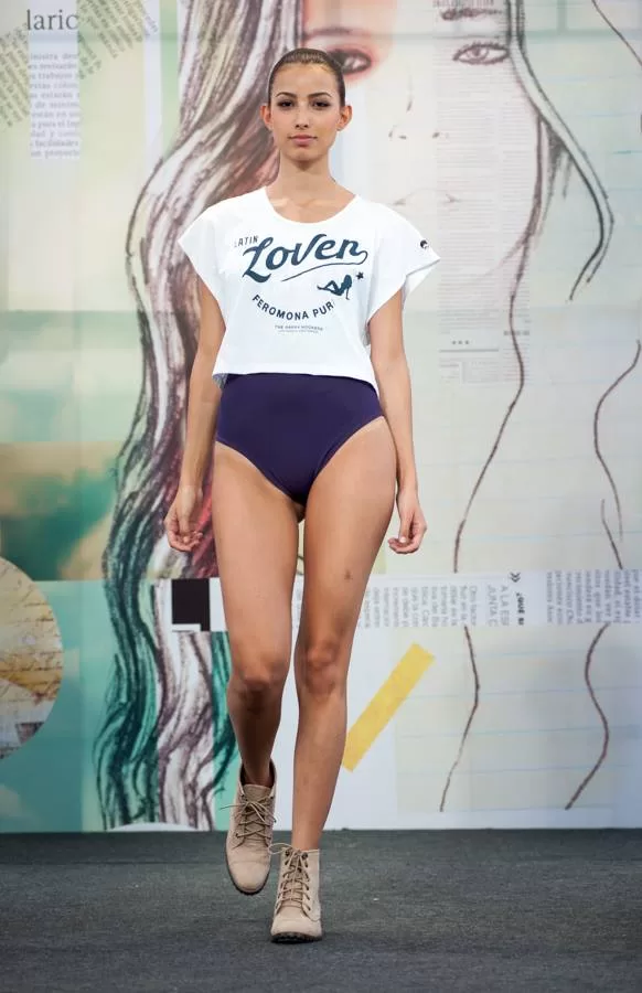 Modelo con camiseta blanca Latin Lover y traje de baño azul marino en la pasarela de El Cubo, Colombiamoda 2013