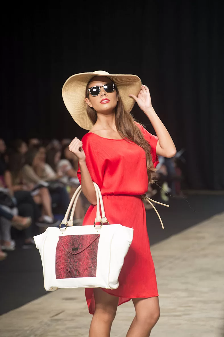 Modelo con pamela, vestido rojo y bolso blanco y rojo de Carolina Ochoa en el SFW 2013